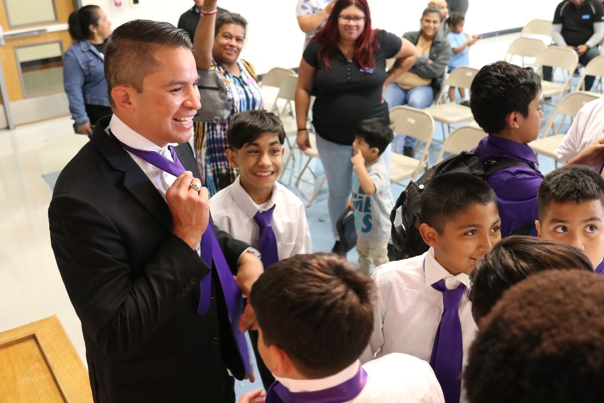 Austin ISD Superintendent Matias Segura joins students at Gus Garcia YMLA for the annual tie tying ceremony