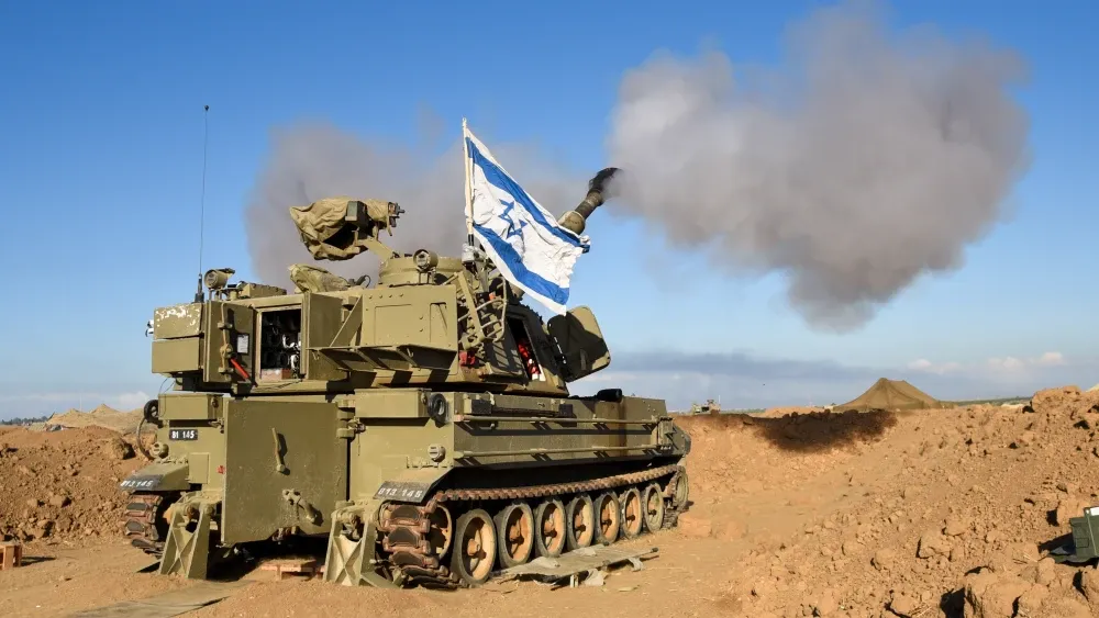An IDF M109 howitzer artillery cannon fires 155mm shells at the Gaza Strip to attack Hamas targets. Gaza Envelope, Israel, October 25, 2023. Shutterstock