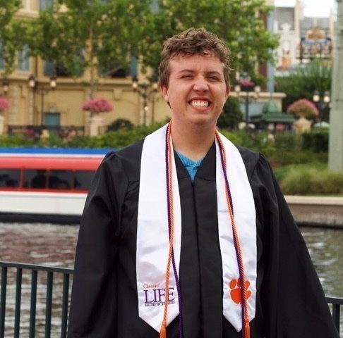 ClemsonLIFE graduate, Jordan, smiling in his graduation regalia.