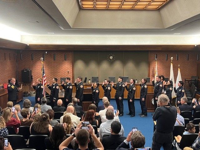 Badge pinning ceremony in City Hall