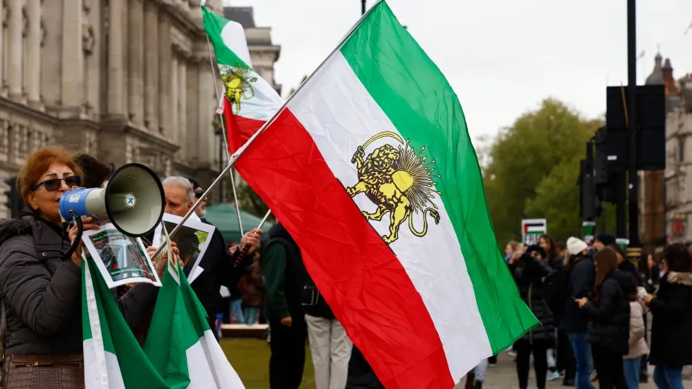 The former flag of Iran is showing up at anti-regime protests, like this one in London in 2024. Shutterstock