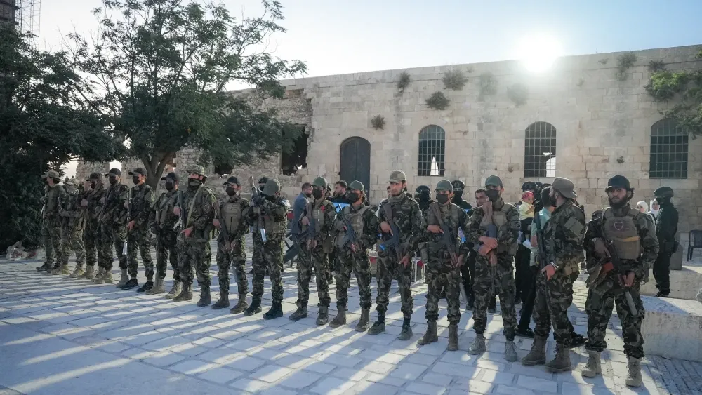 Syrian government fighters during a May 2025 celebration of the lifting of sanctions on Syria. Shutterstock