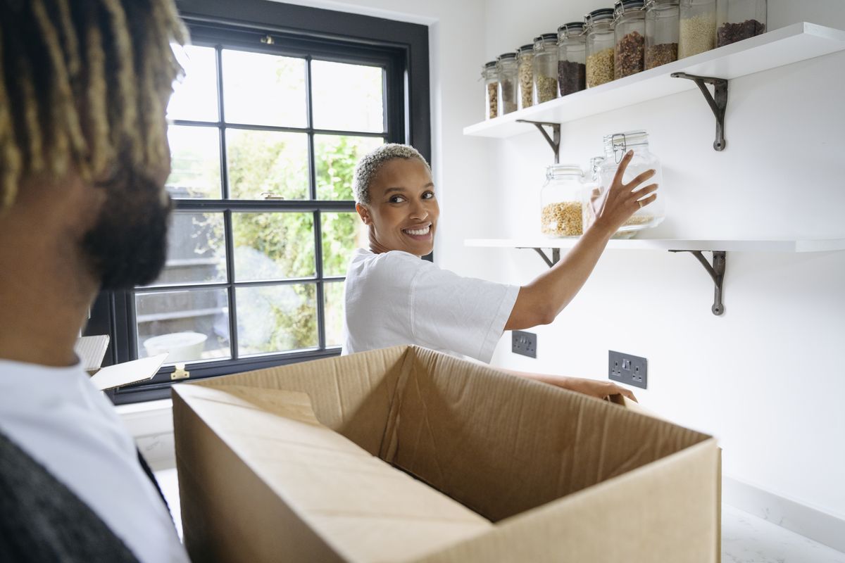 woman placing jar on shelf