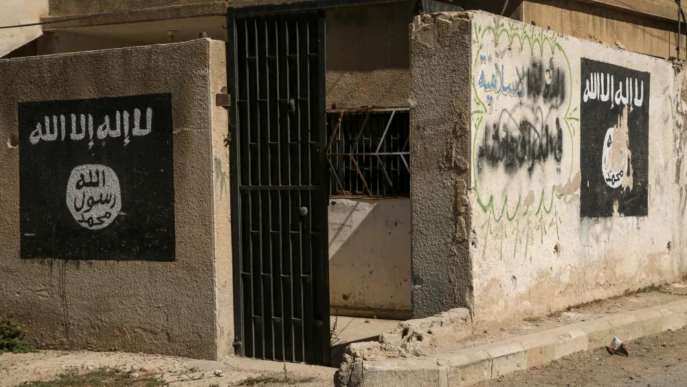 A building in Syria bears graffiti from Islamic State fighters.  Shutterstock
