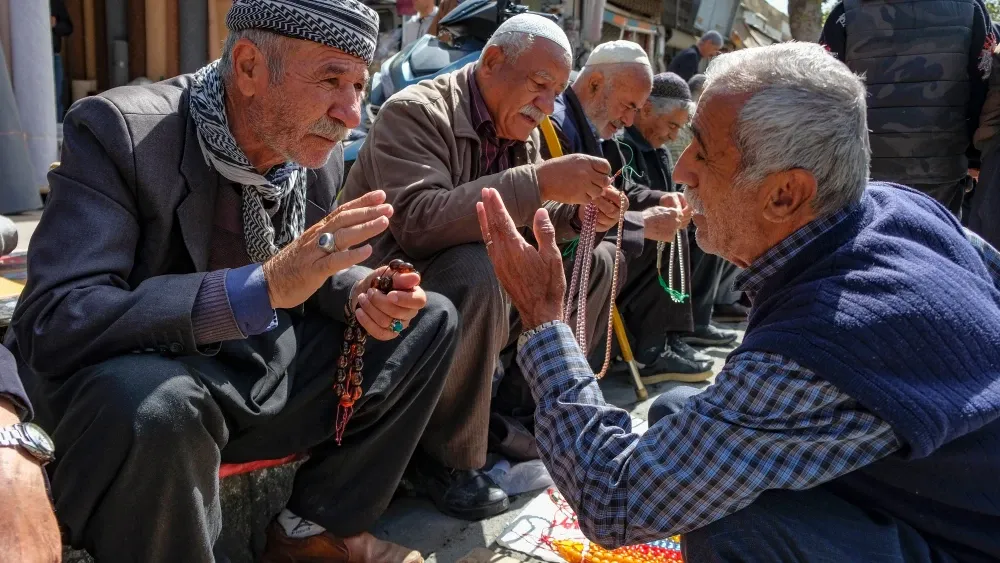 Man sells prayer beads in Kurdistan, Iran