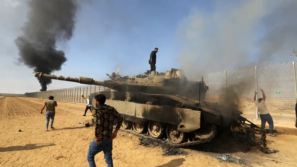 Palestinians and destroyed israeli tank