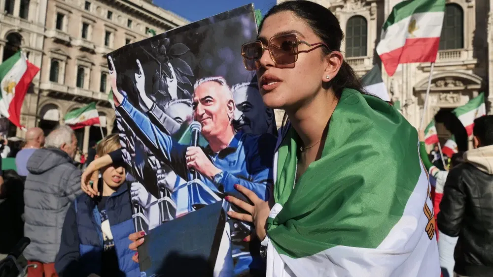 People protest in 2023 against the regime with the former national flag of Iran and supporters of Crown Prince Reza Pahlavi. Shutterstock