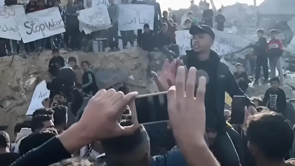 Anti-Hamas protestors marching among the ruins that Hamas brought upon them.