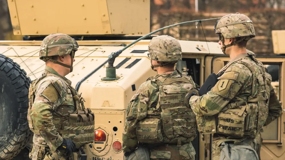 United States Marine Corps troops with an armored vehicle humvee, ready for patrol. Shutterstock