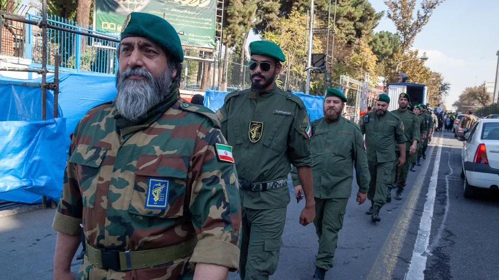A line of Islamic Revolutionary Guard Corps troops cross the street in Tehran, Iran, in 2022. Shutterstock