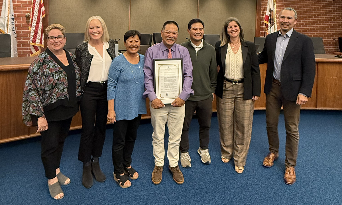 John Chung smiling alongside the City Council