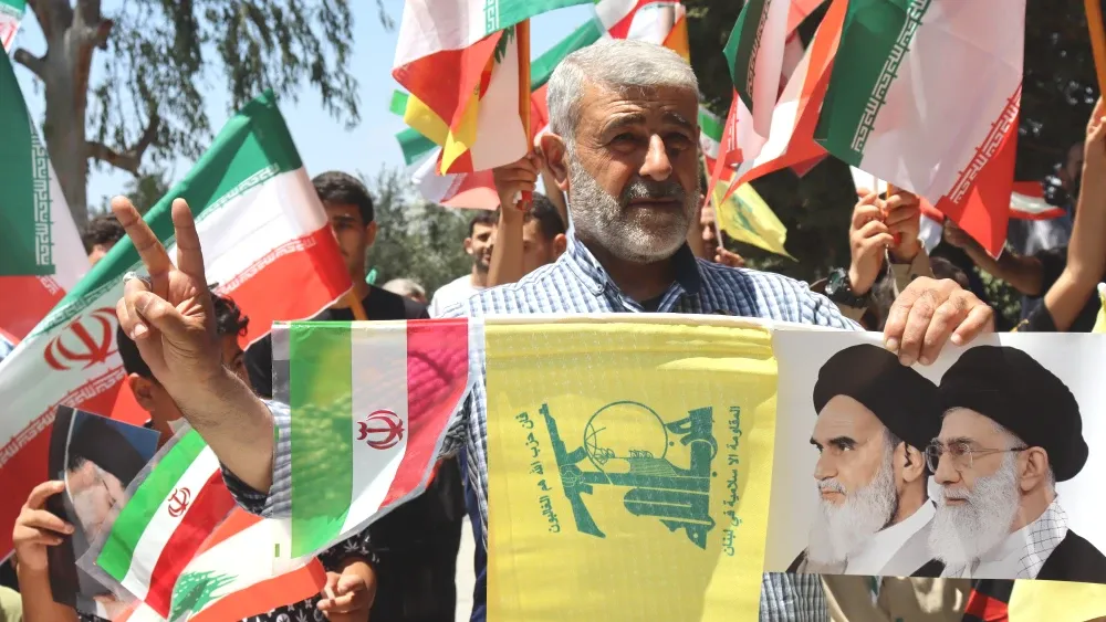 Despite the stated policy of the government, the comprehensive disarmament of the Shi'ite Islamist terrorist group Hezbollah is not happening, and almost certainly will not happen. Supporters wave Ira...