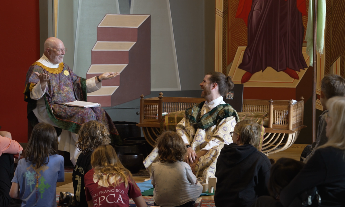 picture of church where the deacon is reading and priest and deacon laugh