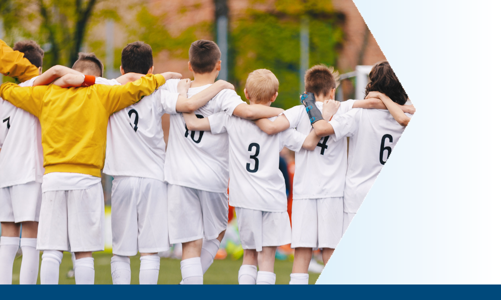 Young soccer players link arms before a game