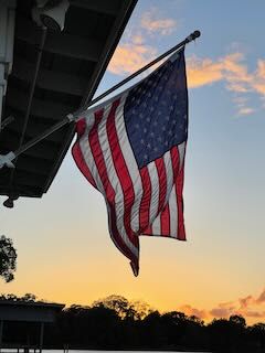 American flag flying at sunset