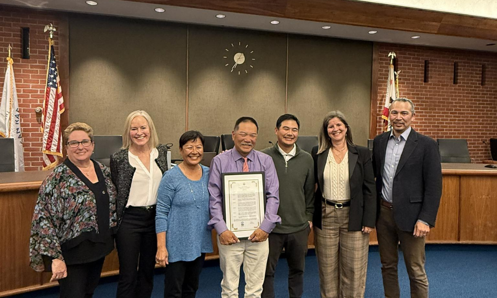 John Chung smiling with family and City Council members