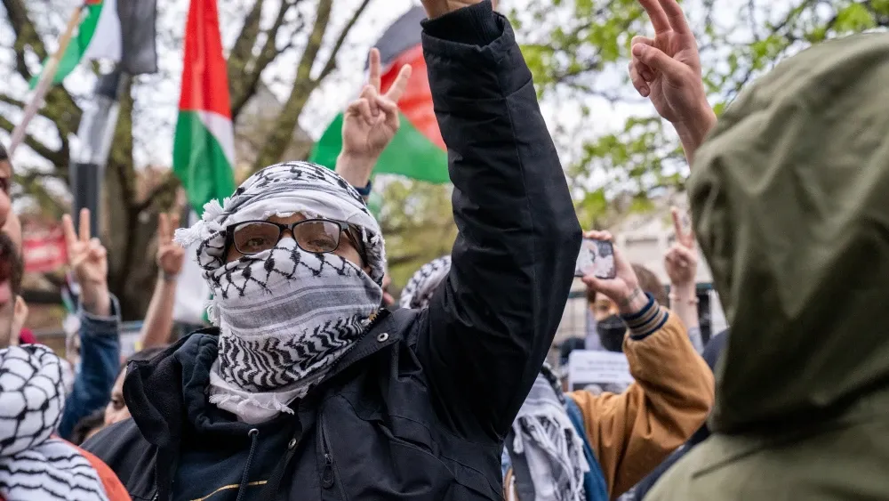 According to a growing cadre of intellectuals in Canada, this protester raising his fist at a rally in Toronto is a potential victim of anti-Palestinian 