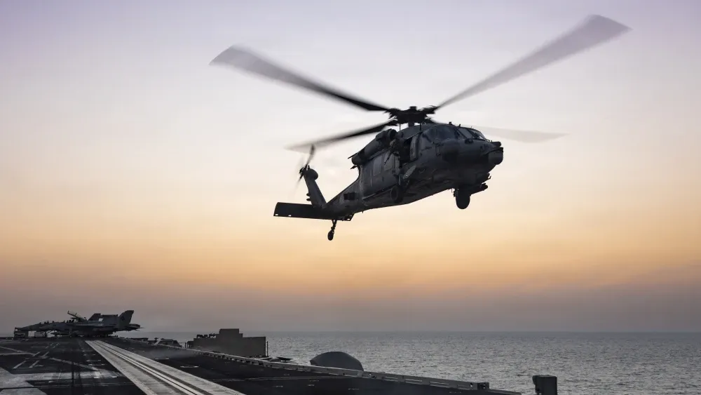 An MH-60S Sea Hawk helicopter, attached to Helicopter Sea Combat Squadron (HSC) 14, lands on the flight deck of Nimitz-class aircraft carrier USS Abraham Lincoln (CVN 72) in support of Operation Epic ...