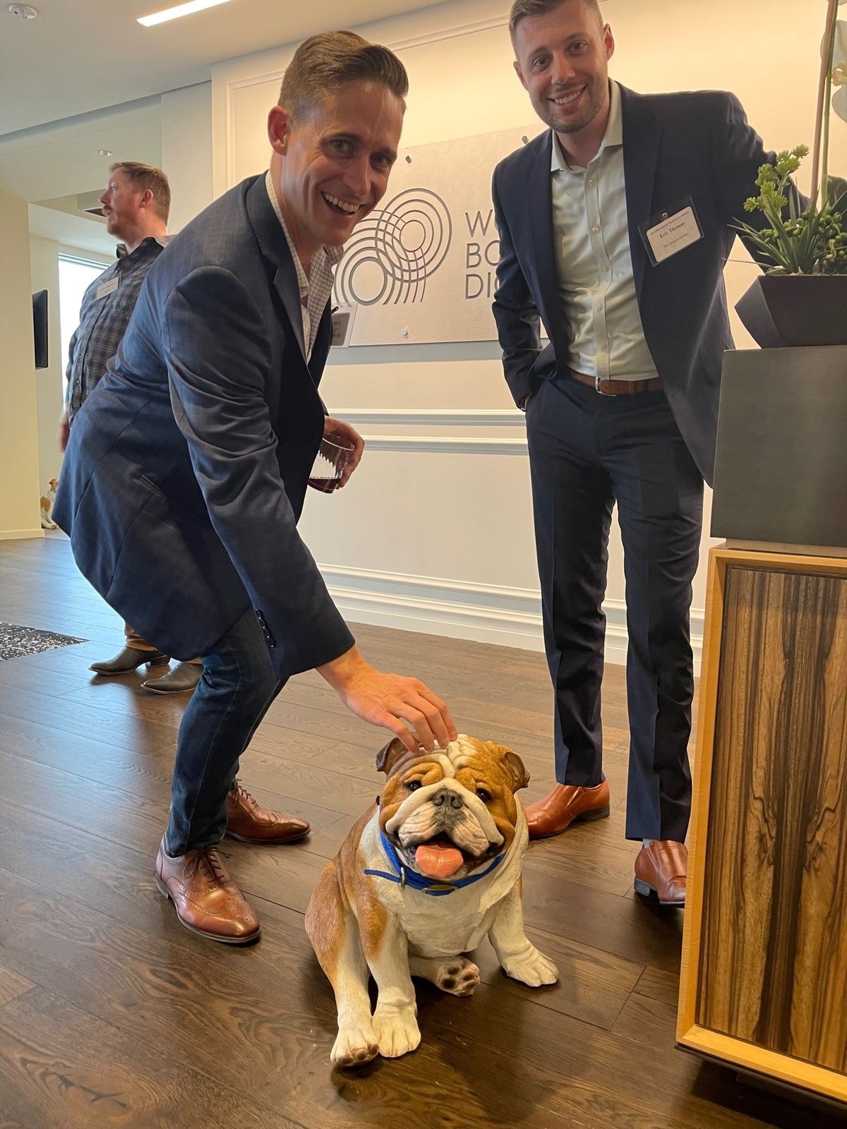 two men and realistic dog sculpture