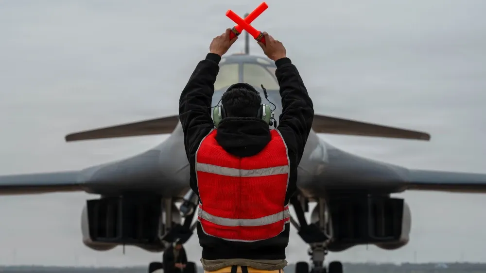 A U.S. Air Force B-1B Lancer crew chief marshals a B-1 after returning from a mission in support of Operation Epic Fury, March 4, 2026. The B-1B is a long-range, multi-role bomber.  U.S. Air Force pho...