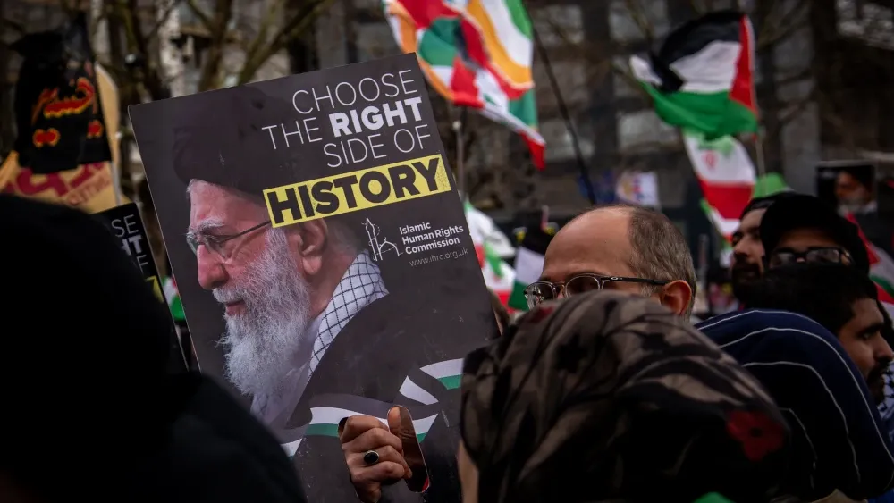 Activists associated with the Islamic Human Rights Commissioned, a registered charity in the U.K., protest in favor of the repressive regime in Iran at a recent protest in London.  (Shutterstock)
