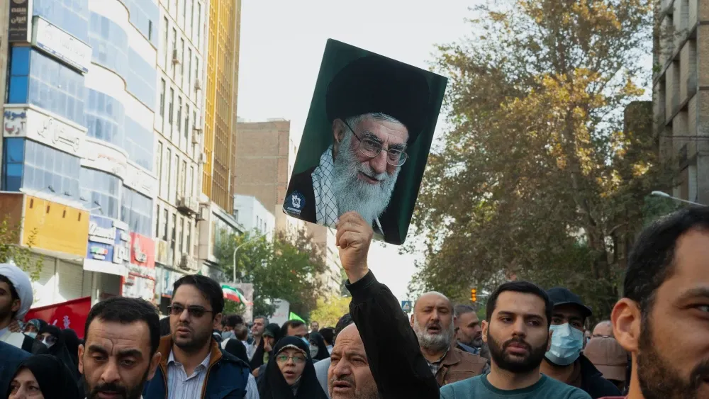 supporter holds up a photo of Ayatollah Khamenei in Tehran. Shutterstock