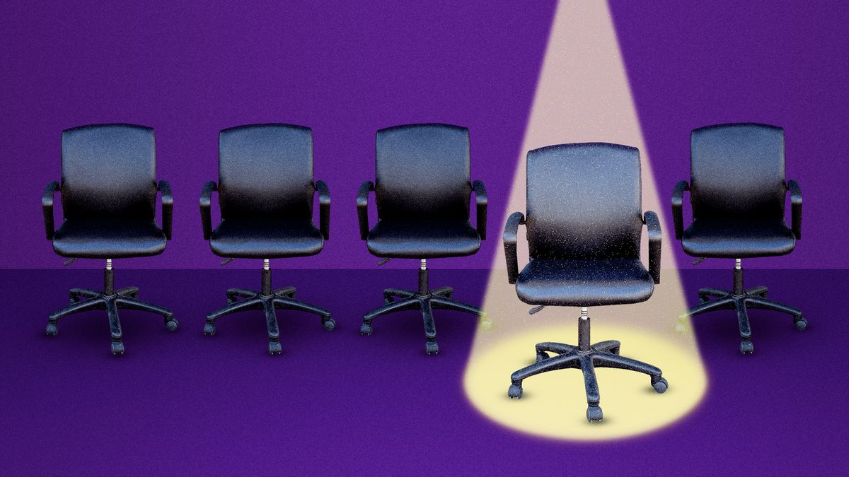 One desk chair spotlighted among many
