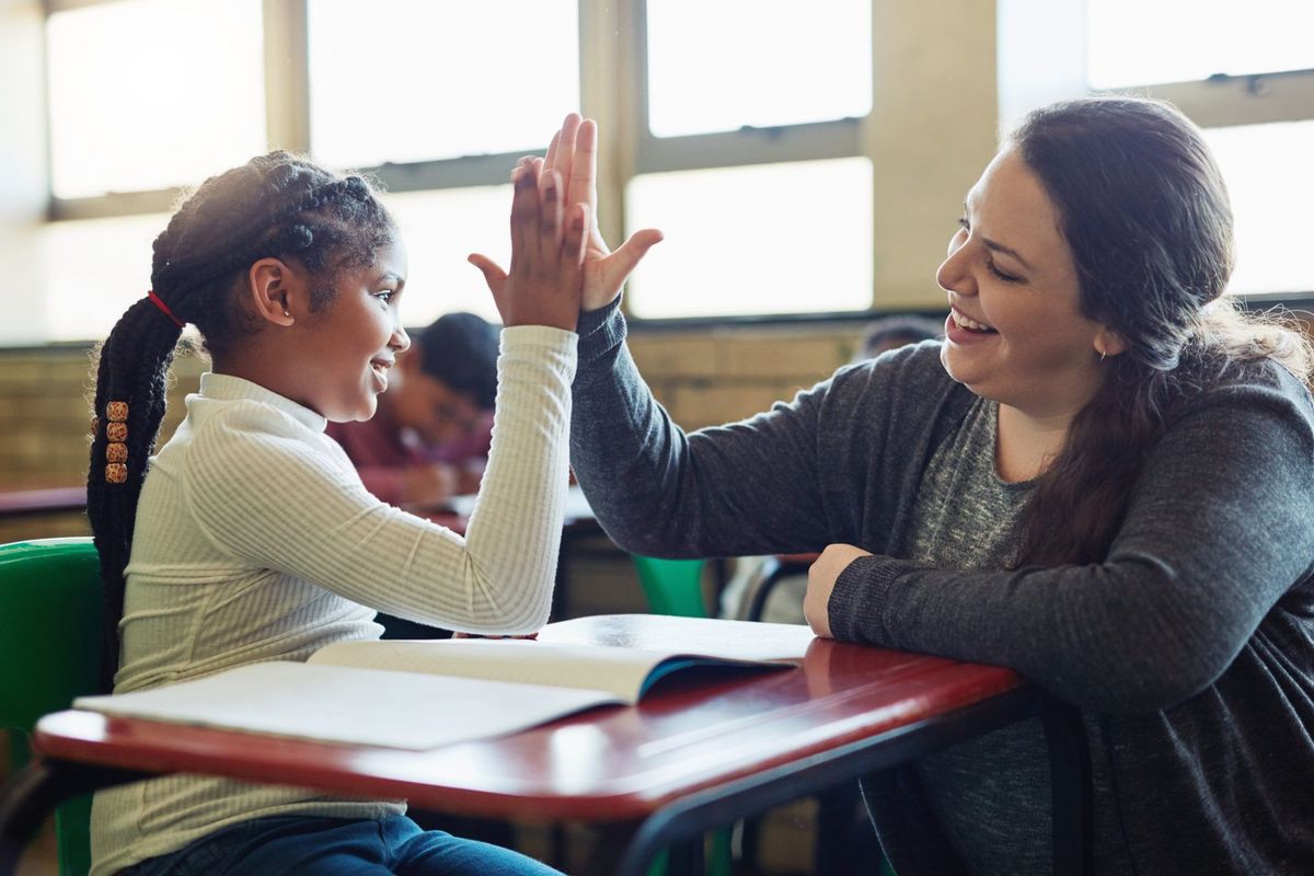 Teacher high fiving student