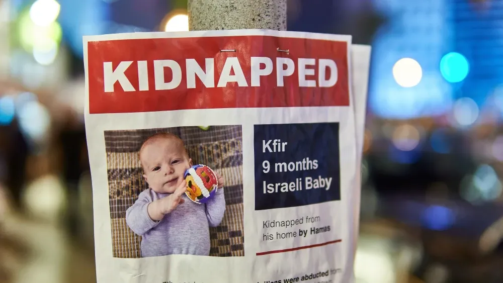 A poster of Kfir Bibas, who along with his brother Ariel and his mother Shiri was murdered in captivity by Hamas terrorists in Gaza. Photo made in Tel Aviv on Oct. 21, 2023. Shutterstock