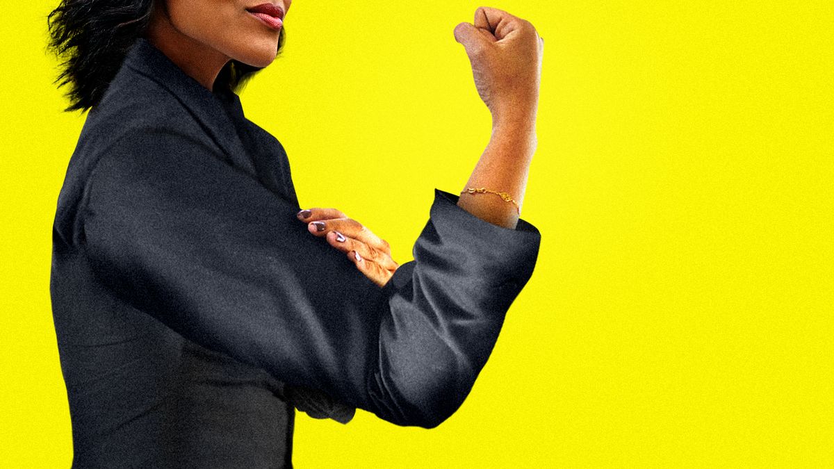 Woman in a suit flexing