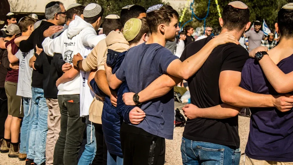 Young Israeli men gather at Hostages Square in Tel Aviv in memory of those still in captivity in Gaza from the terrorist attack of October 7, 2023.  Shutterstock