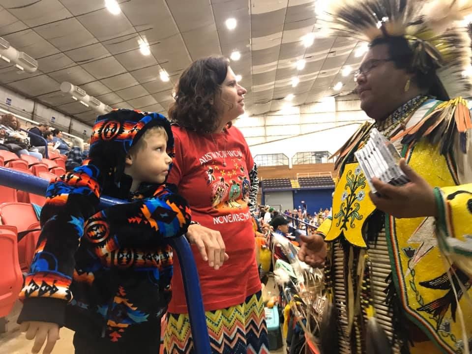 Parent and student at 2019 Austin Powwow with Potawatomi Dancer 
