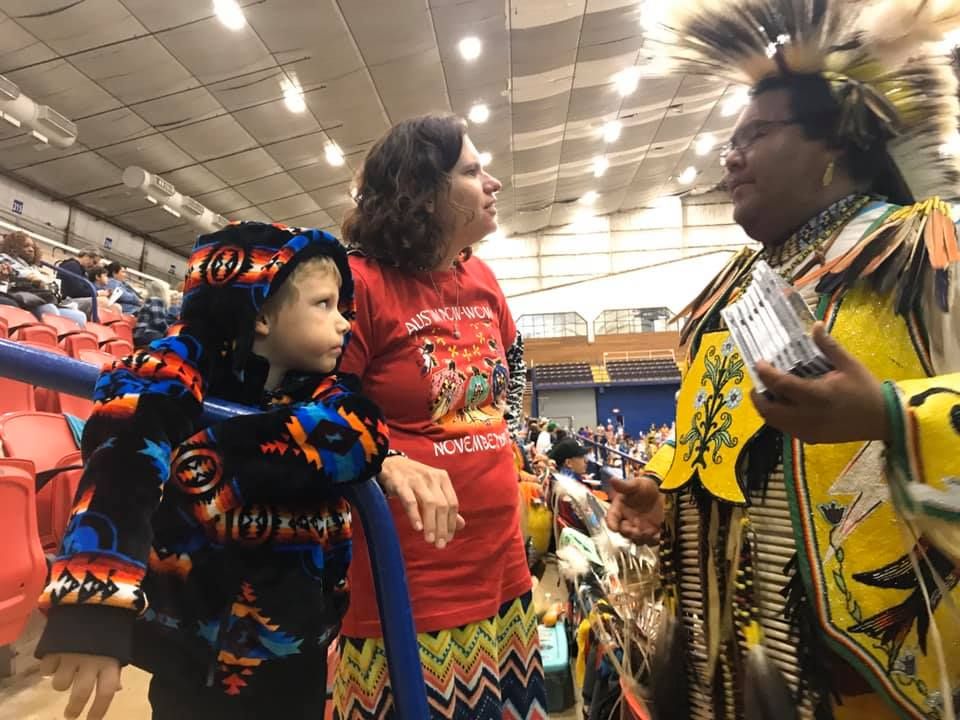 Parent and student at 2019 Austin Powwow with Potawatomi Dancer