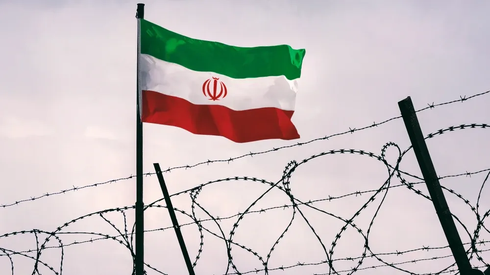 While a seventy-year-old Iranian woman with a bleeding mouth shouts that she has been 