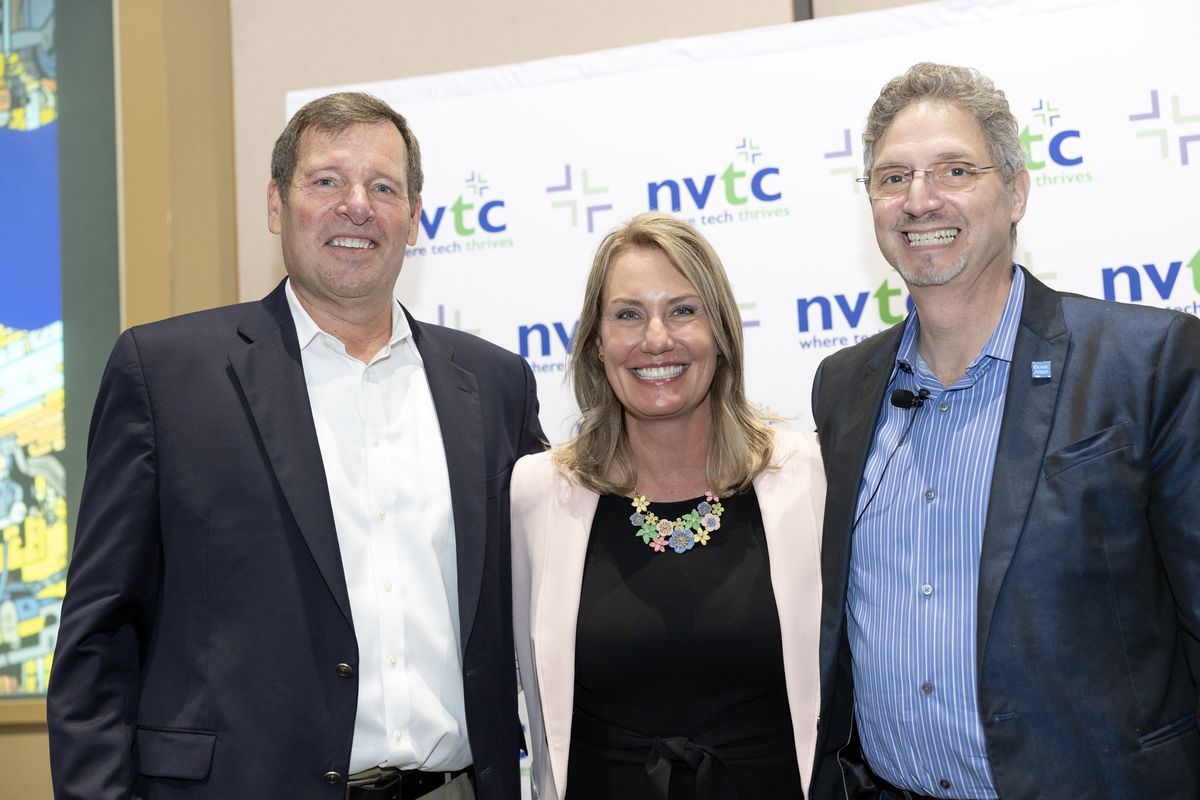 Group of two men and one woman at NVTC Impact AI Summit