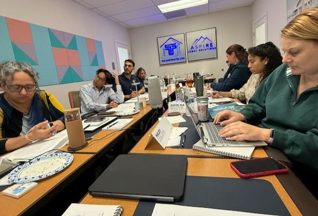 Group of people around table studying