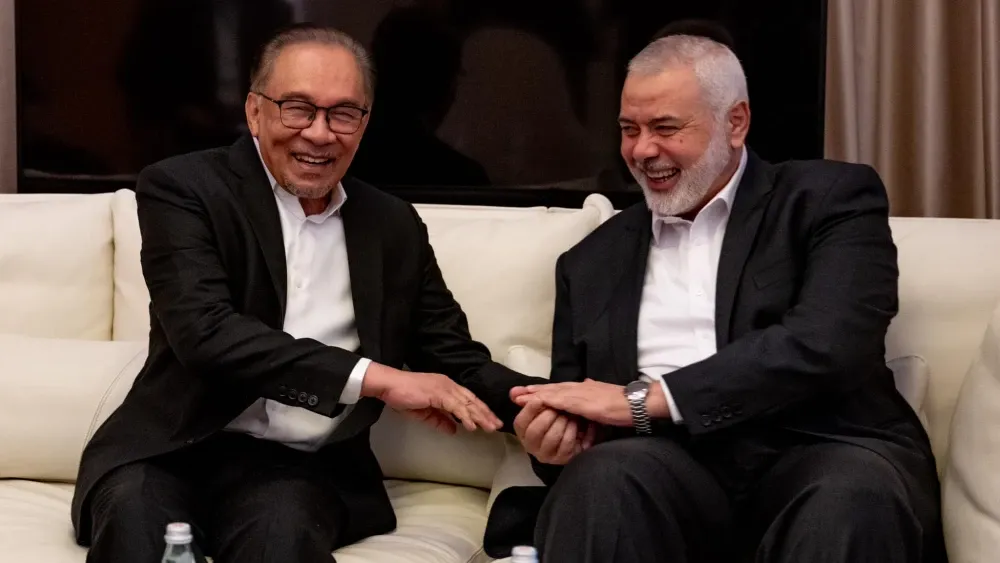 Anwar Ibrahim, prime minister of Malaysia and a top official of a Virginia Islamist network, meets and embraces the late terrorist leader Ismail Haniyeh in 2024, just months after Haniyeh and his terr...