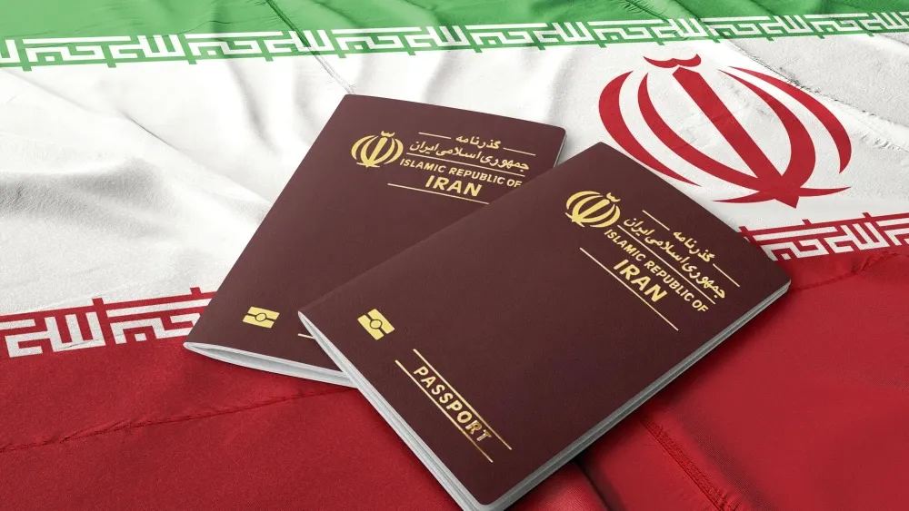 Iranian passports lie on an Iranian flag.  Shutterstock