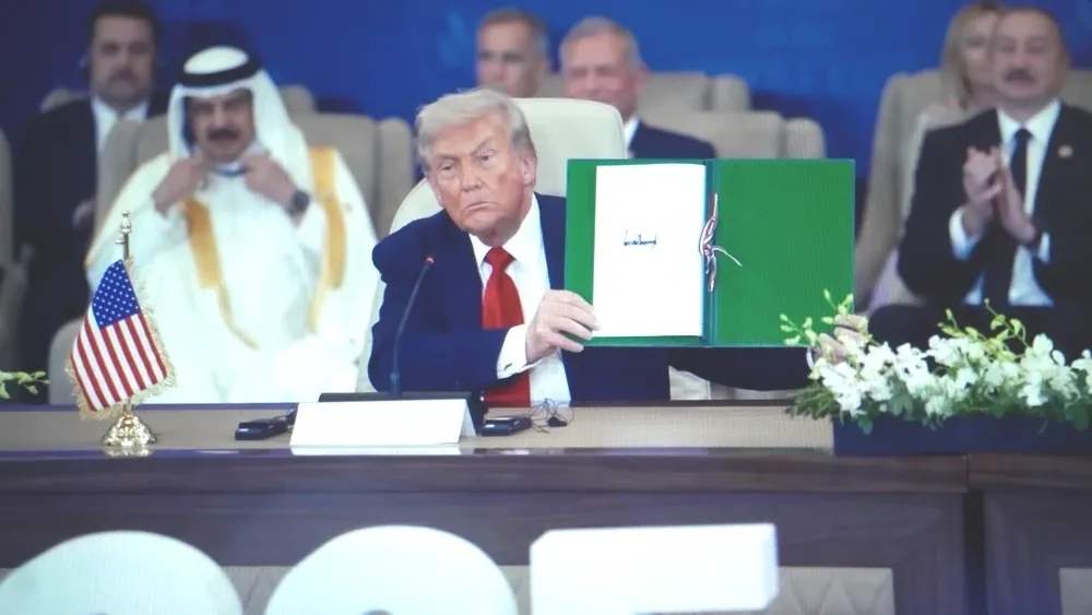 President Donald Trump poses with the signed Middle East peace declaration at the summit on ending the Gaza war in Sharm El-Sheikh, Egypt, on October 13, 2025.  Shutterstock