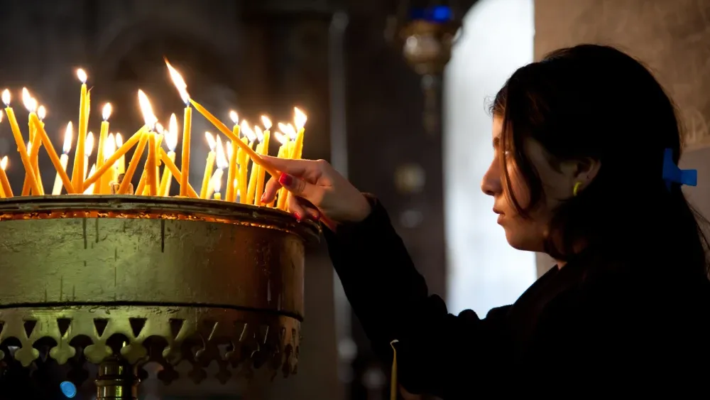 Israel's global standing depends on its relations with the Christian world. The vast majority of the Zionists in the world are Christian. A girl lights a prayer candle in the Church of the Nativity, t...