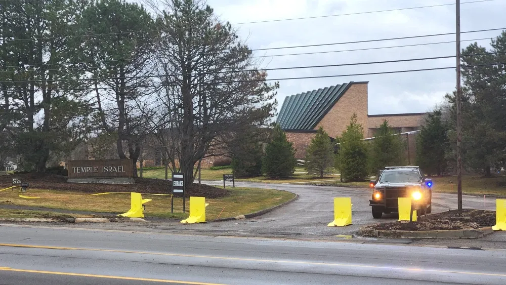 Entrance to Temple Israel in West Bloomfield, Michigan, the day after the vehicle-ramming attack of March 12, 2026. A police truck operated by the Oakland County Sheriff's Office guards the entrance. ...