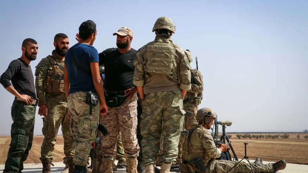 U.S. and Turkish soldiers discuss the bombing of Islamic State positions in Aleppo, Syria, in September 2017.  Shutterstock