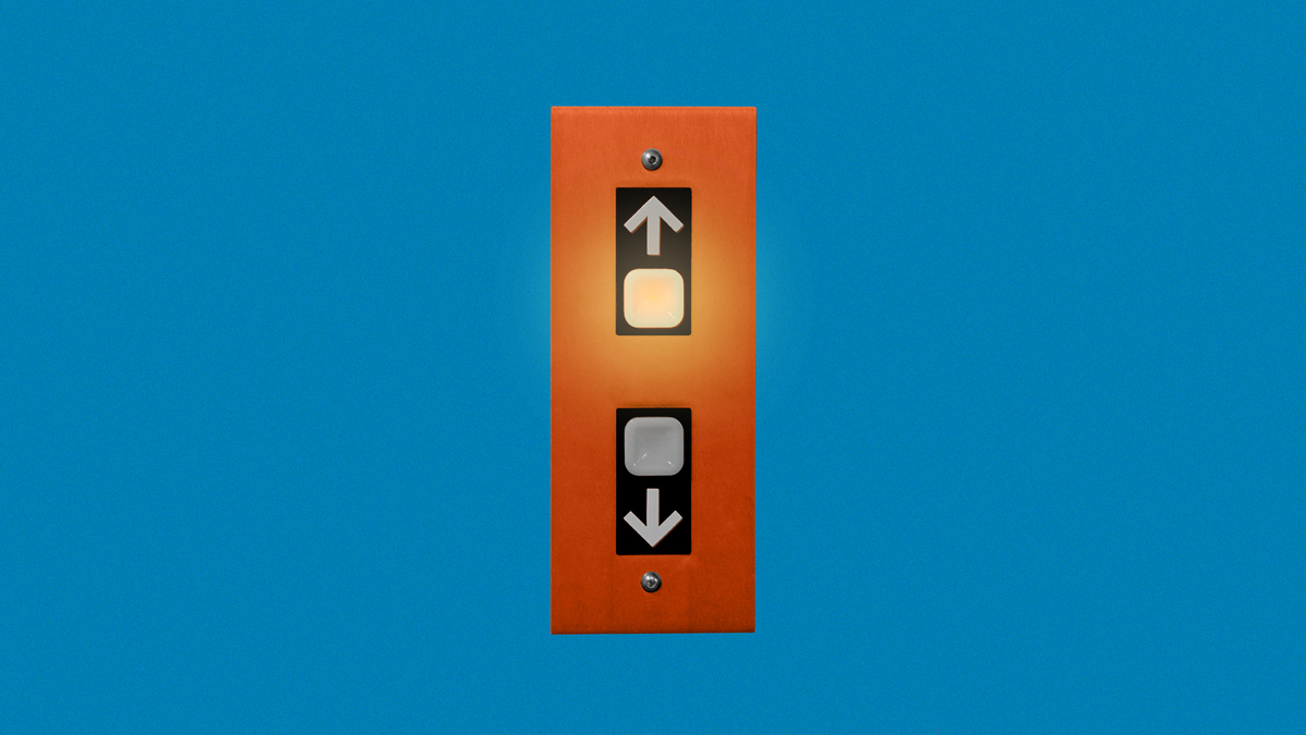 An elevator button for going up that is lit up, and an elevator button for going down that is not lit up.