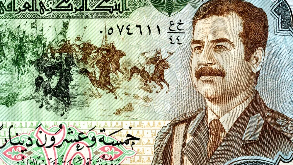 A portrait of Saddam Hussein (1937-2006) on an Iraqi banknote.  Shutterstock
