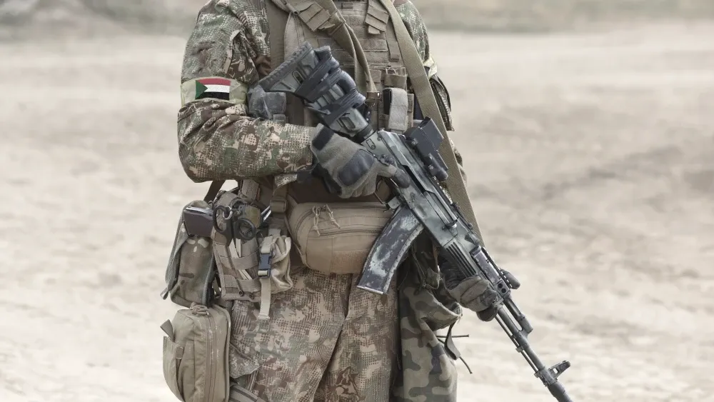 A soldier's armband has the flag of Sudan.  Shutterstock