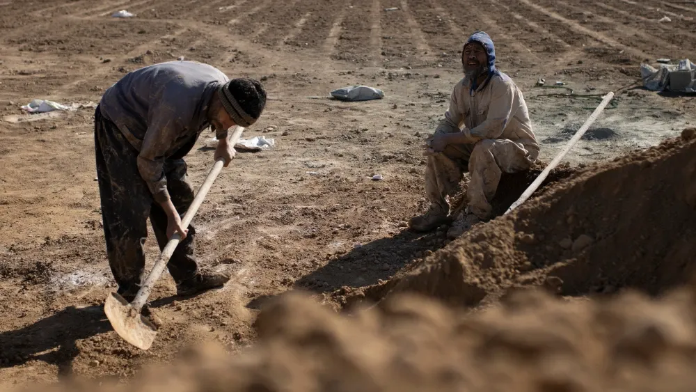 Afghan immigrant workers at a cemetery in Tehran, Iran. Shutterstock