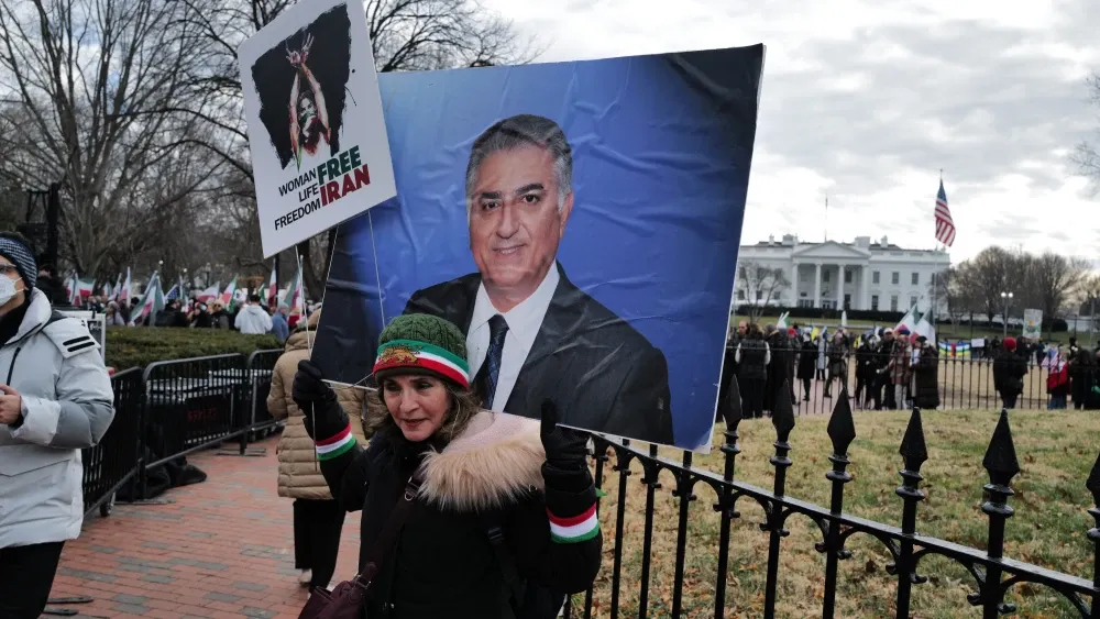 Posters of exiled Crown Prince Reza Pahlavi were displayed at an anti–Islamic Republic protest in Washington, D.C., on January 17, 2026.  Shutterstock