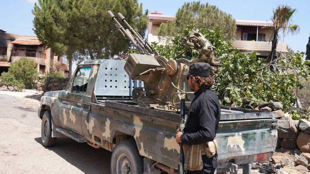 Fighters and military vehicles belonging to the Syrian government forces in al-Suwayda', Syria; July 20, 2025.  Shutterstock