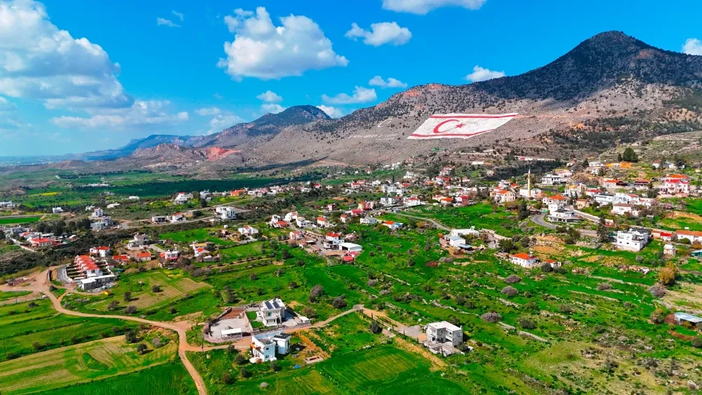 The flag of the Turkish Republic of Northern Cyprus on a mountain in Northern Cyprus, which Turkey occupies.  Shutterstock