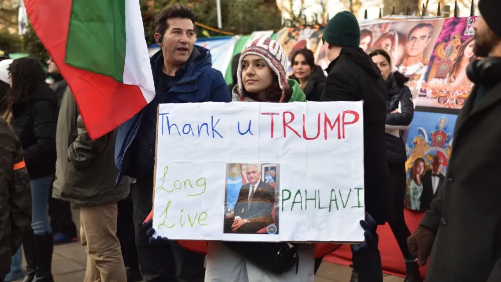A protester against the Islamic Republic holds up a sign during a demonstration in London on January 3, 2026.  Shutterstock